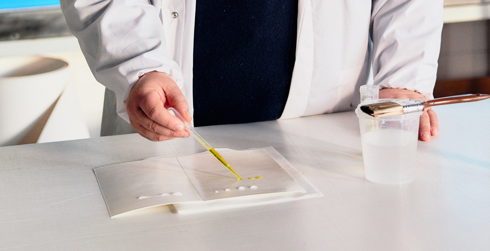 Man testing leak-proof carboard material in a lab
