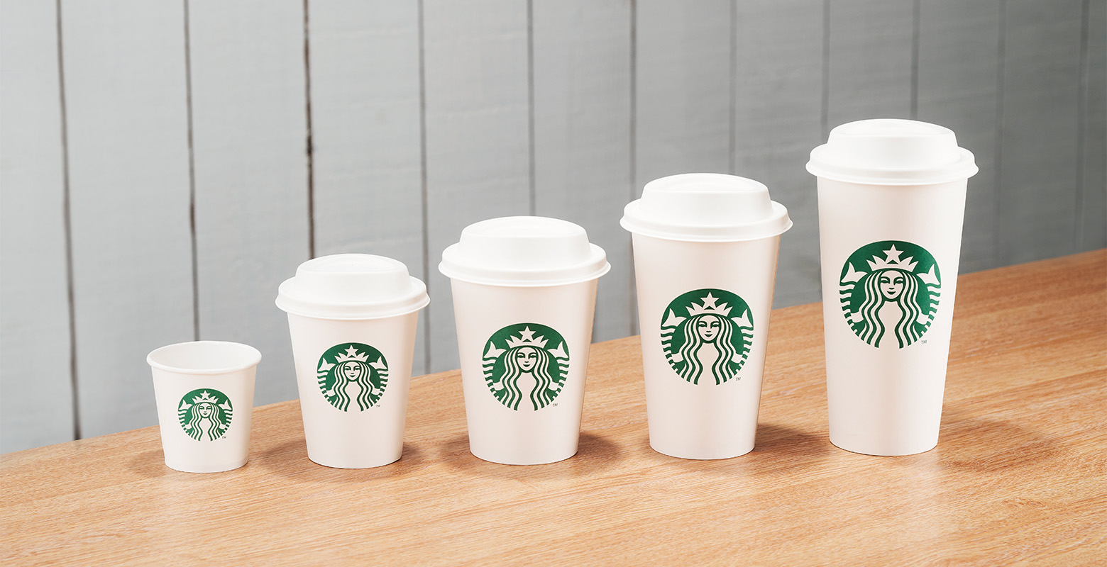 A line of Starbucks cups from small espresso size, to large Venti size